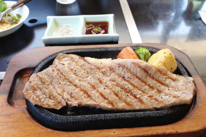 This is a steak of Iki beef from the famous Iki restaurant "Aji-dokoro Umeshima". The Iki beef steak is served on a hot iron plate.